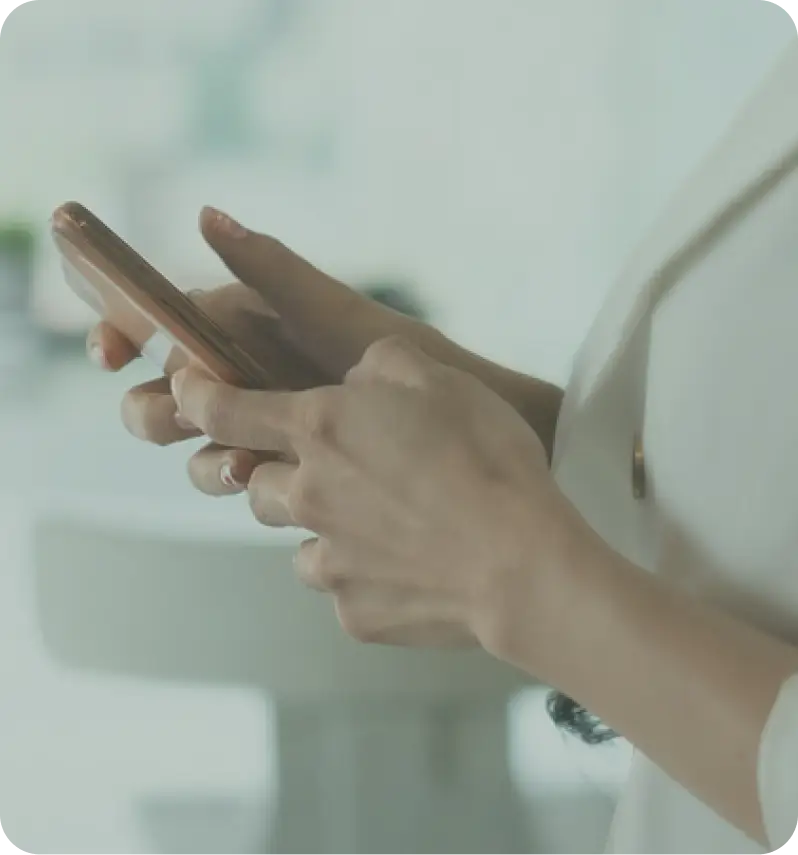 Close-up of a woman’s hands holding a smartphone, ready to engage in a business consultation.